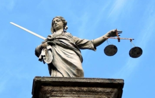 large lady justice statue on building