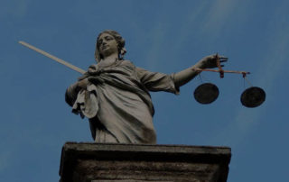 large statue of lady justice on a building