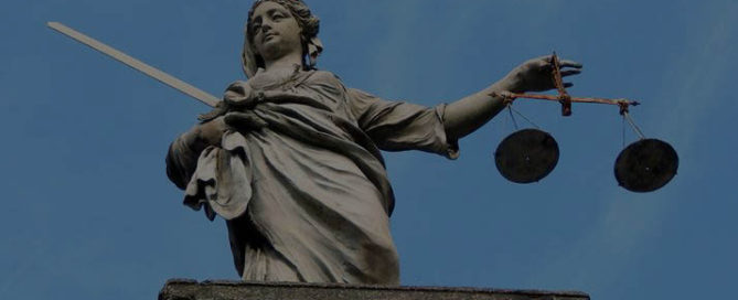 large statue of lady justice on a building