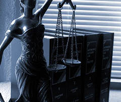 statue of the balanced scales of justice on a desk