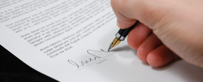 hand signing a legal document