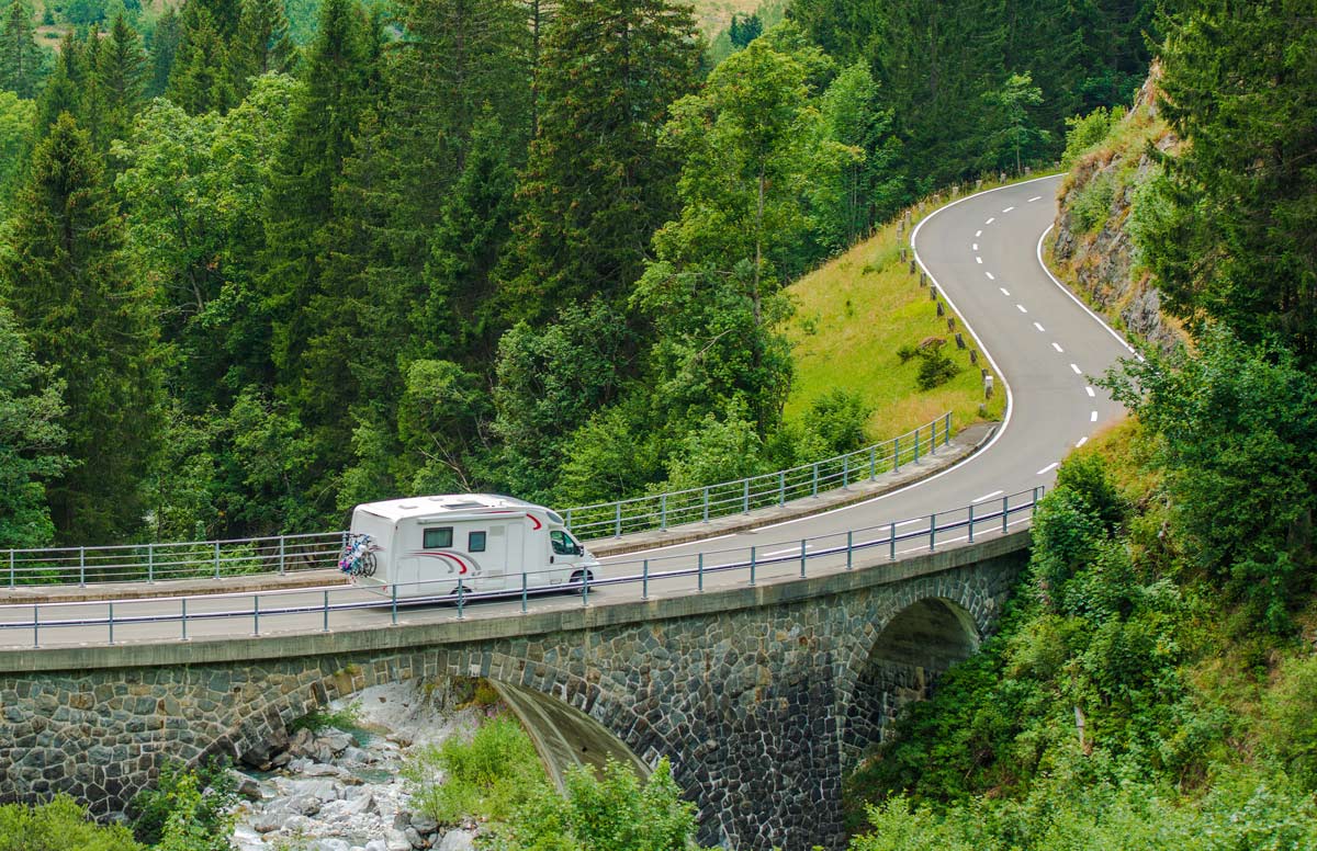 RV driving on a winding road in nature