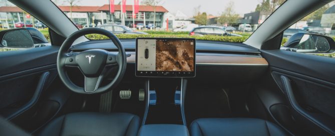 front seats and view out of a tesla car