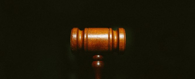 top of a judge's gavel on a black background